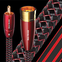 Close-up of high-quality audio cables with red and black braided texture. Cables feature red connectors, labelled "Red River," set against a black background.