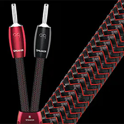 Close-up of two audio speaker cables with textured red and black braided design. One cable has a red connector, the other a black. 